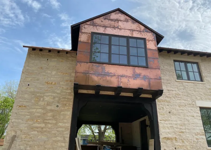 Copper metal panel facade on a stone building for Skylight Installation in Westampton