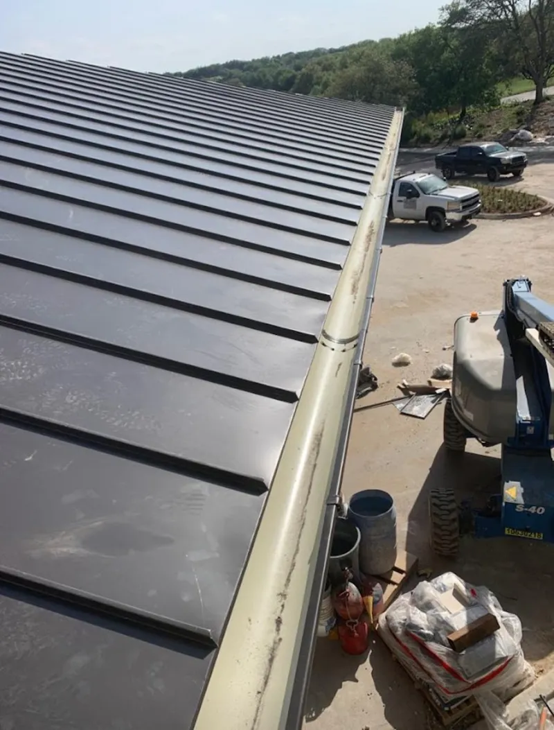 Standing seam panel and gutter detail on a metal roofing jobsite in Westampton